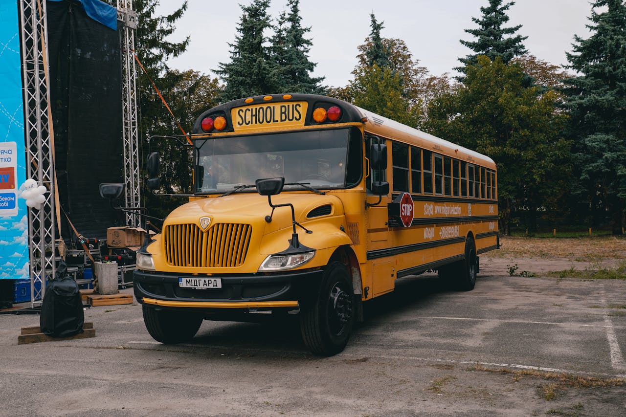 A classic yellow school bus parked at an event in Kyiv, showcasing a unique cultural twist on a familiar icon.
